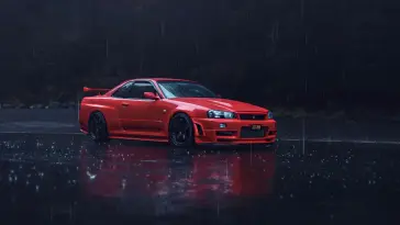 Red Nissan Parked on the Road Under the Rain live wallpaper download
